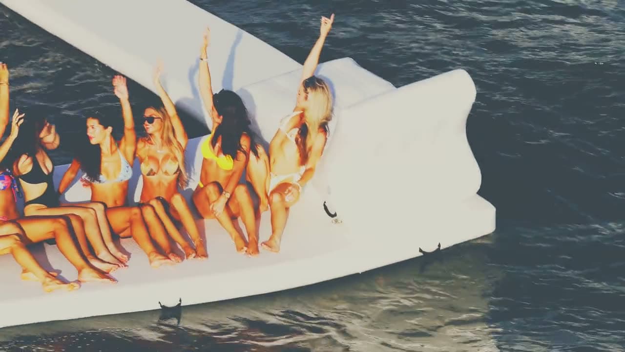 A group celebrating on a yacht's water float