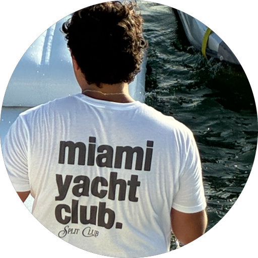 A SplitClub member on the water in Miami wearing a SplitClub tee