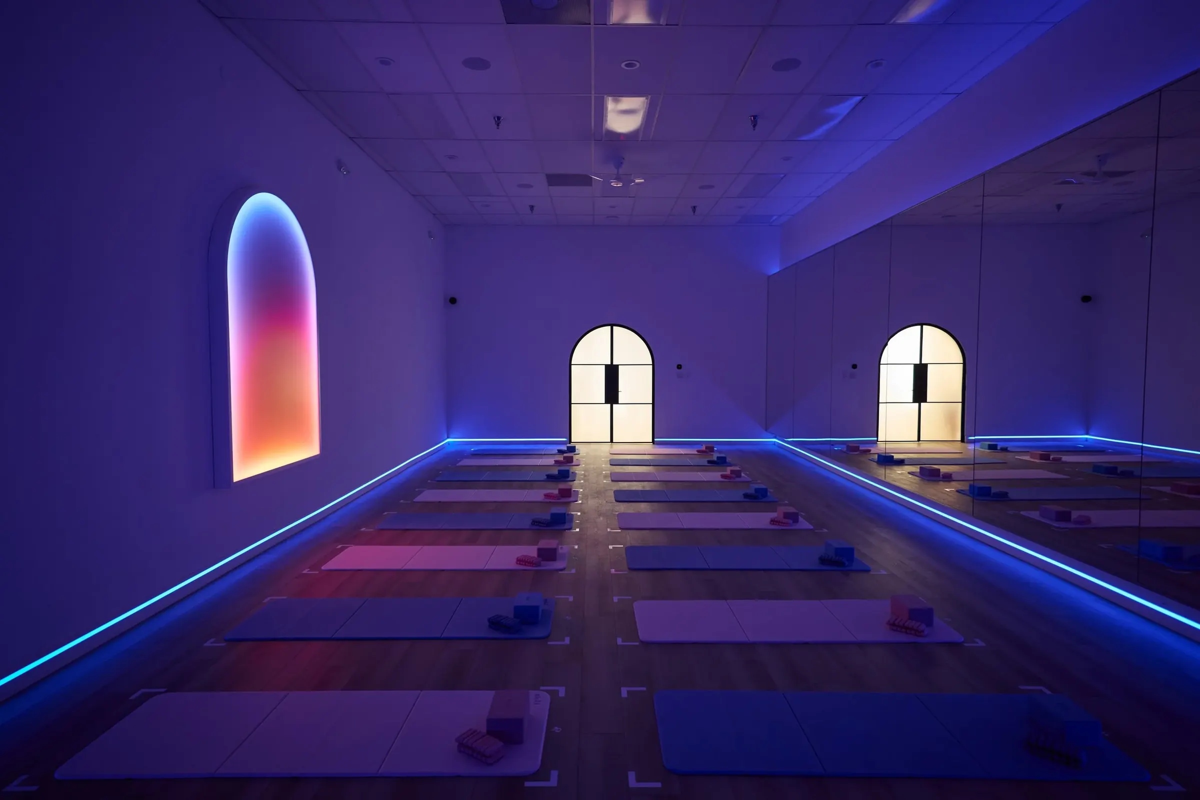 The Portal studio room lit in infrared, mats laid out under glowing arched windows