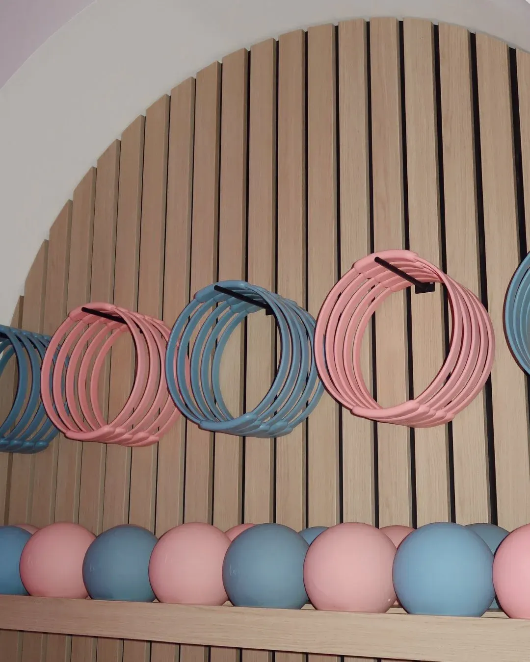 The prop wall: pink and blue rings above rows of soft balls